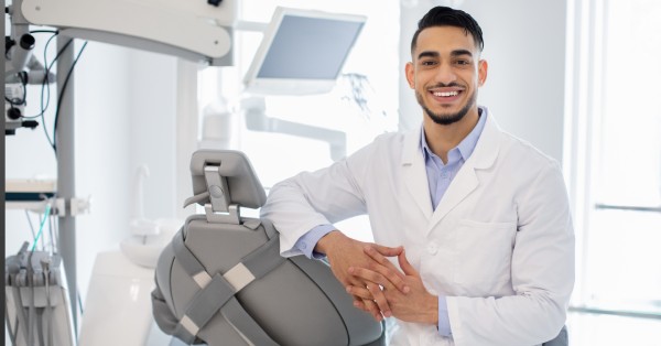A smiling dentist in a modern dental office, representing a dentist near me in Grand Prairie for local dental care.